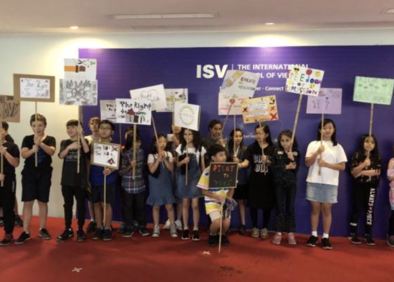 Students holding a sign about equal opportunities